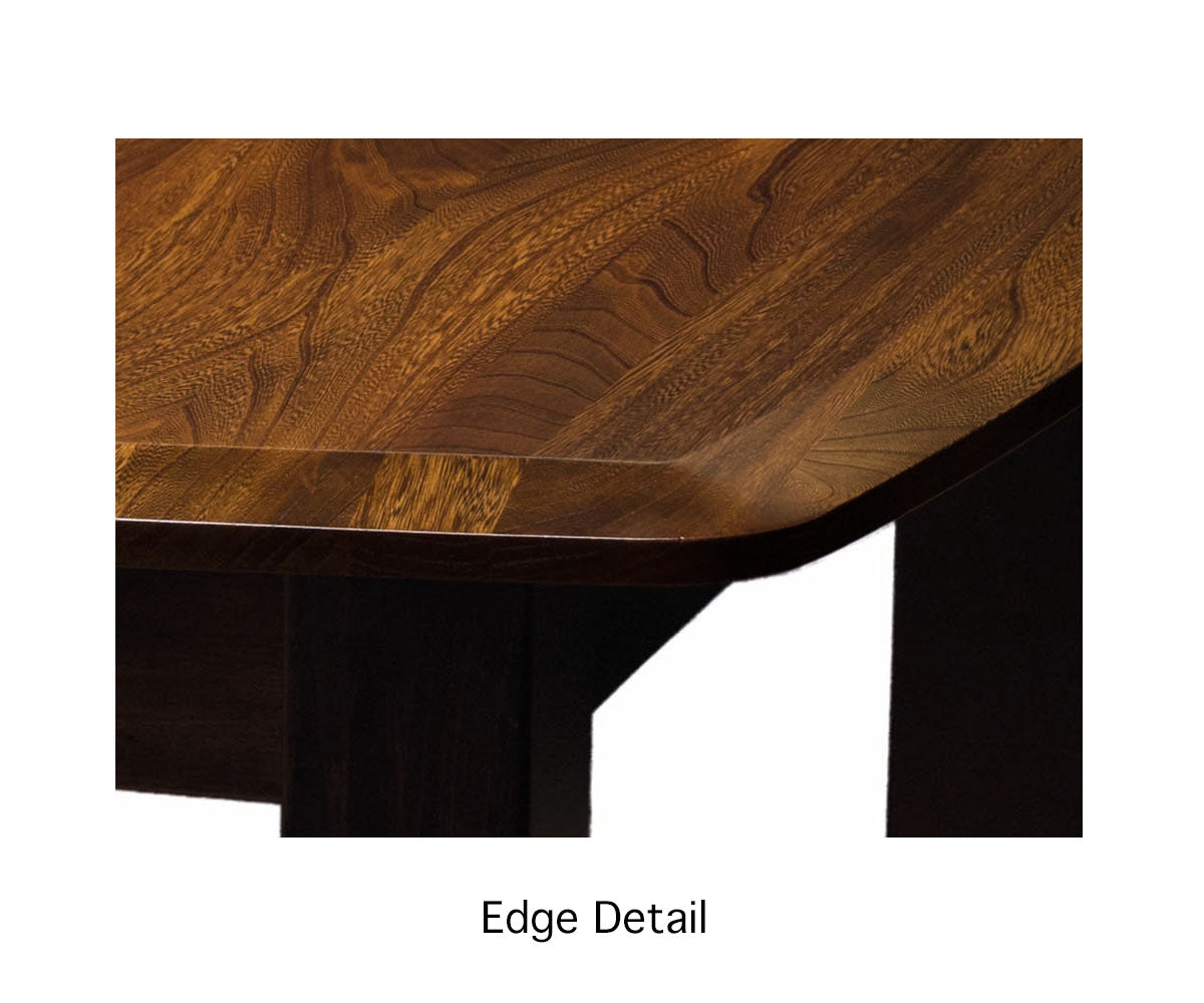 Close-up view of the Christy Trestle Extension Dining Table's edge, showcasing the intricate grain patterns of grey elm and brown maple.