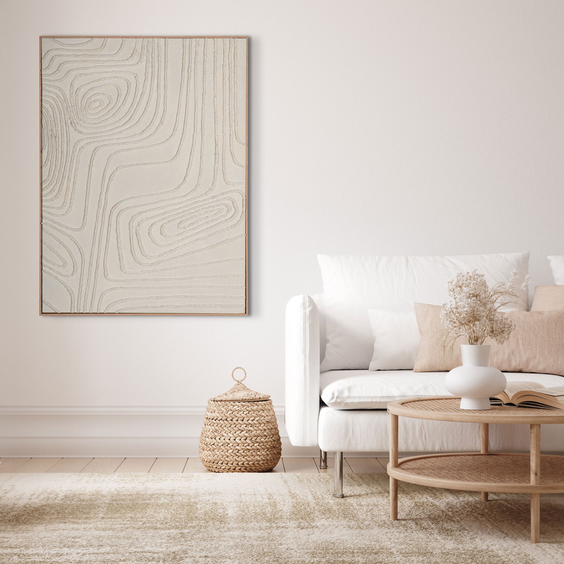 Abstract wall art with topographical textures in soft white tones, styled in a modern living room.