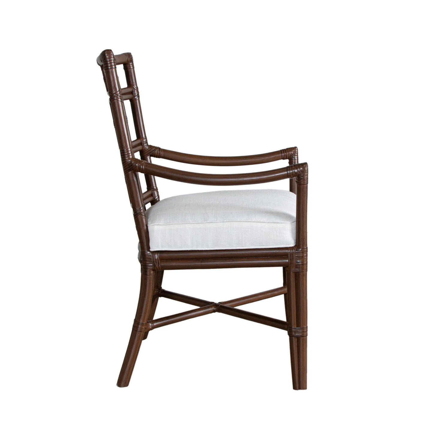 Side view of the Seville Armchair in light mocha rattan, highlighting the curved armrests and tight boxed seat.