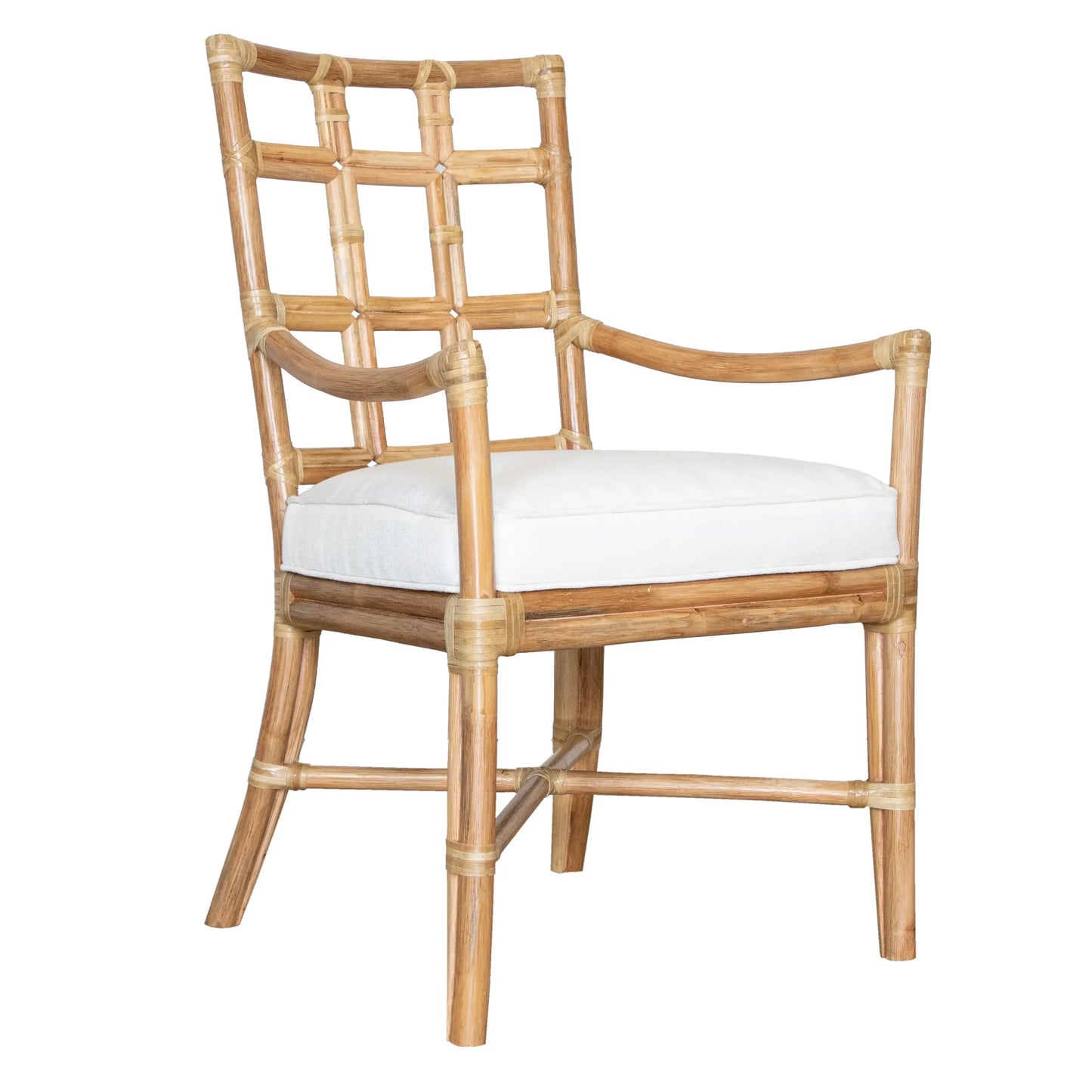 Angled front view of the Seville Armchair in natural rattan, capturing its sophisticated style and craftsmanship.