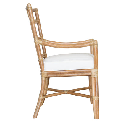 Side view of the Seville Armchair in natural rattan, focusing on the sturdy frame and sleek design.