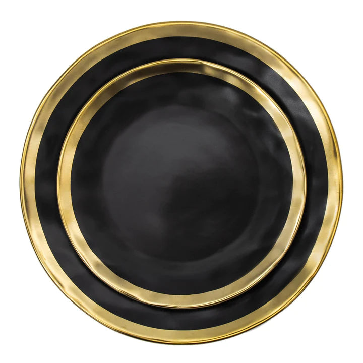 Close-up of black porcelain plates with wide gold band details.