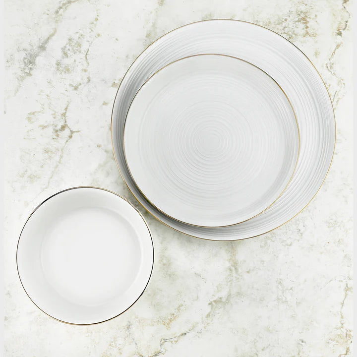 Godinger white porcelain dinnerware set with ripple texture and gold rims, featuring plates and bowl.