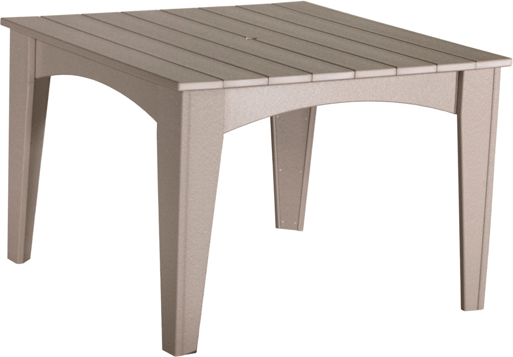 Versatile weatherwood dining table, blending seamlessly with various outdoor color schemes.