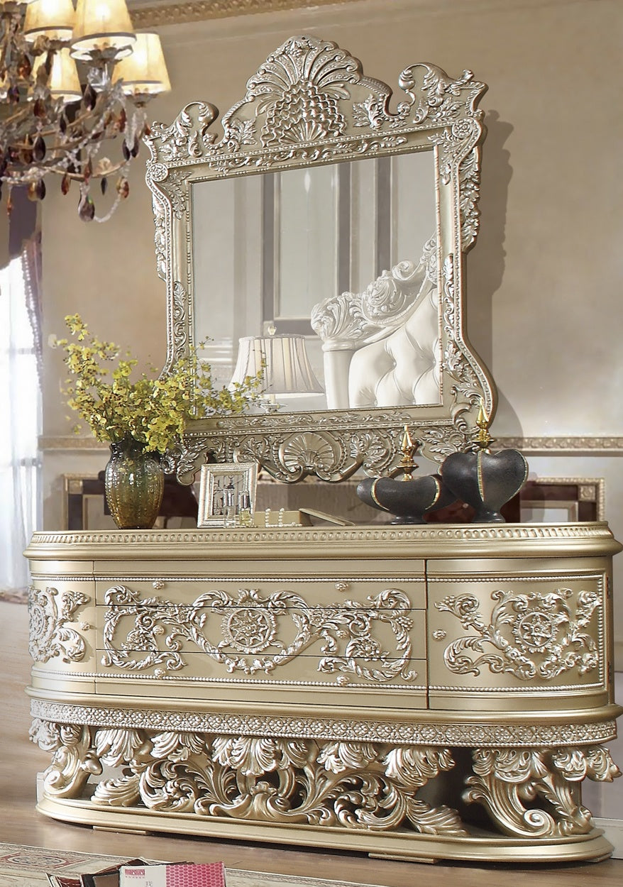 Luxury dining buffet with intricate scrollwork and champagne finish with silver highlights.