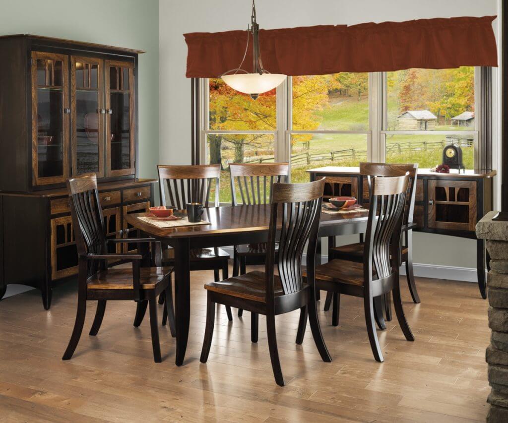 Christy Dining Server in a cozy dining room setting, crafted from Brown Maple and Grey Elm with OCS 230 Onyx and OCS 113 Michael’s Cherry finishes, surrounded by matching chairs.