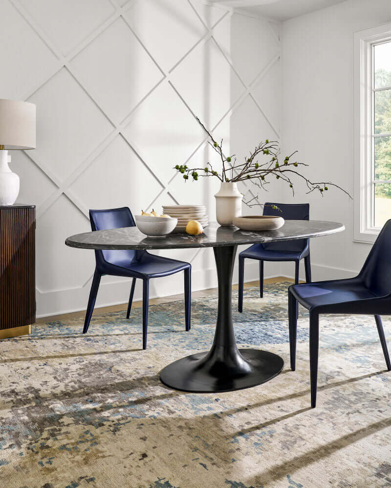 Surya Hanks Navy Dining Chair set in a modern dining room, paired with a black round table.