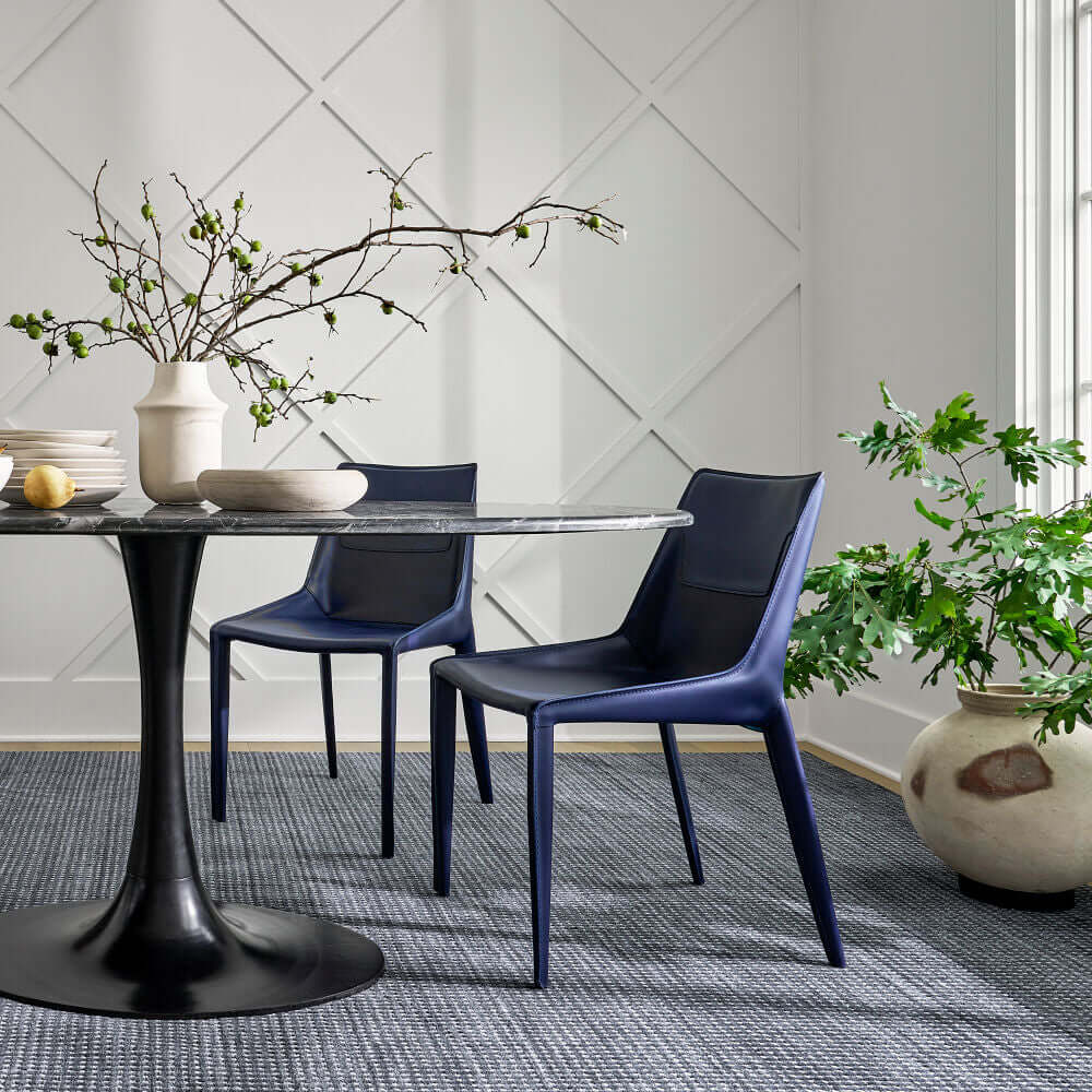 Side view of Hanks Navy Dining Chair in a styled dining room - Surya blue leather dining chair.