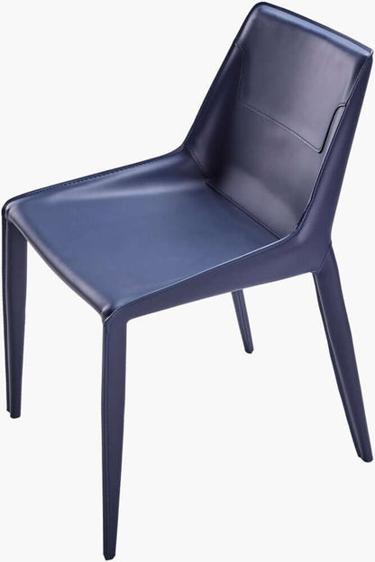 Angled view of Surya Hanks Navy Dining Chair, highlighting the sleek design and blue leather finish.