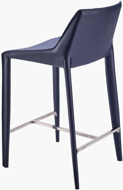 Back view of Surya Hanks Navy Bar Stool, showcasing the elegant blue leather upholstery and sturdy metal legs with a footrest.