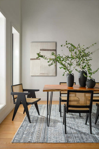 Side view of the Bergen dining table highlighting its sleek iron legs and natural wood grain.