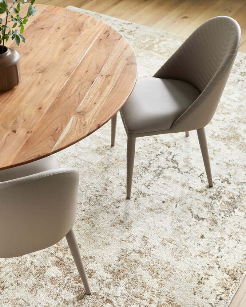 Top view of the Lacey beige leather dining chair by Surya with a wooden dining table.