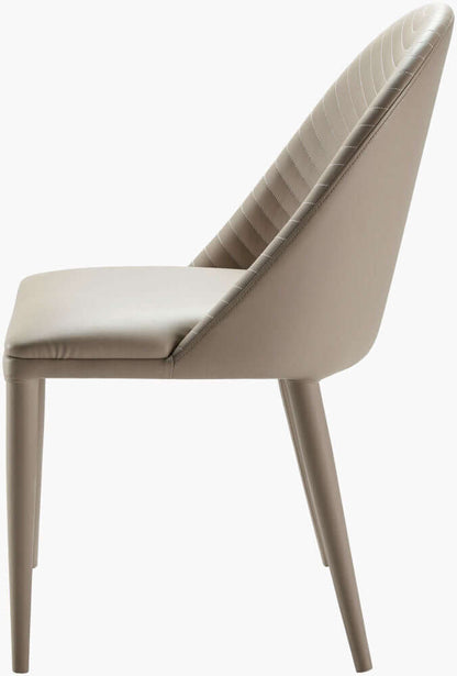 Side view of the Lacey beige leather dining chair by Surya illustrating its sleek profile.