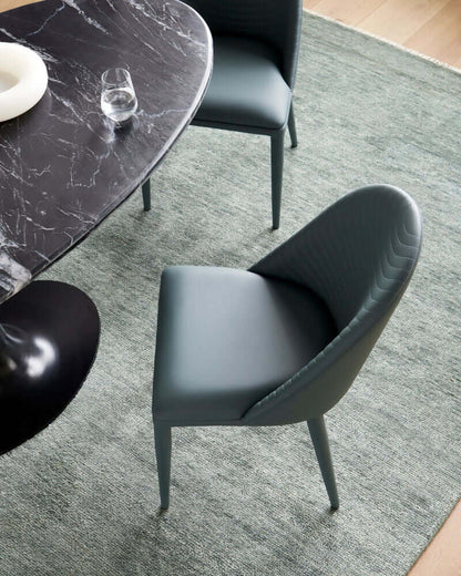 Top view of a Lacey Teal Dining Chair around a black marble dining table