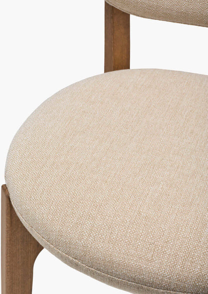 Detailed view of the Devin Dining Chair's backrest with luxurious cream upholstery.