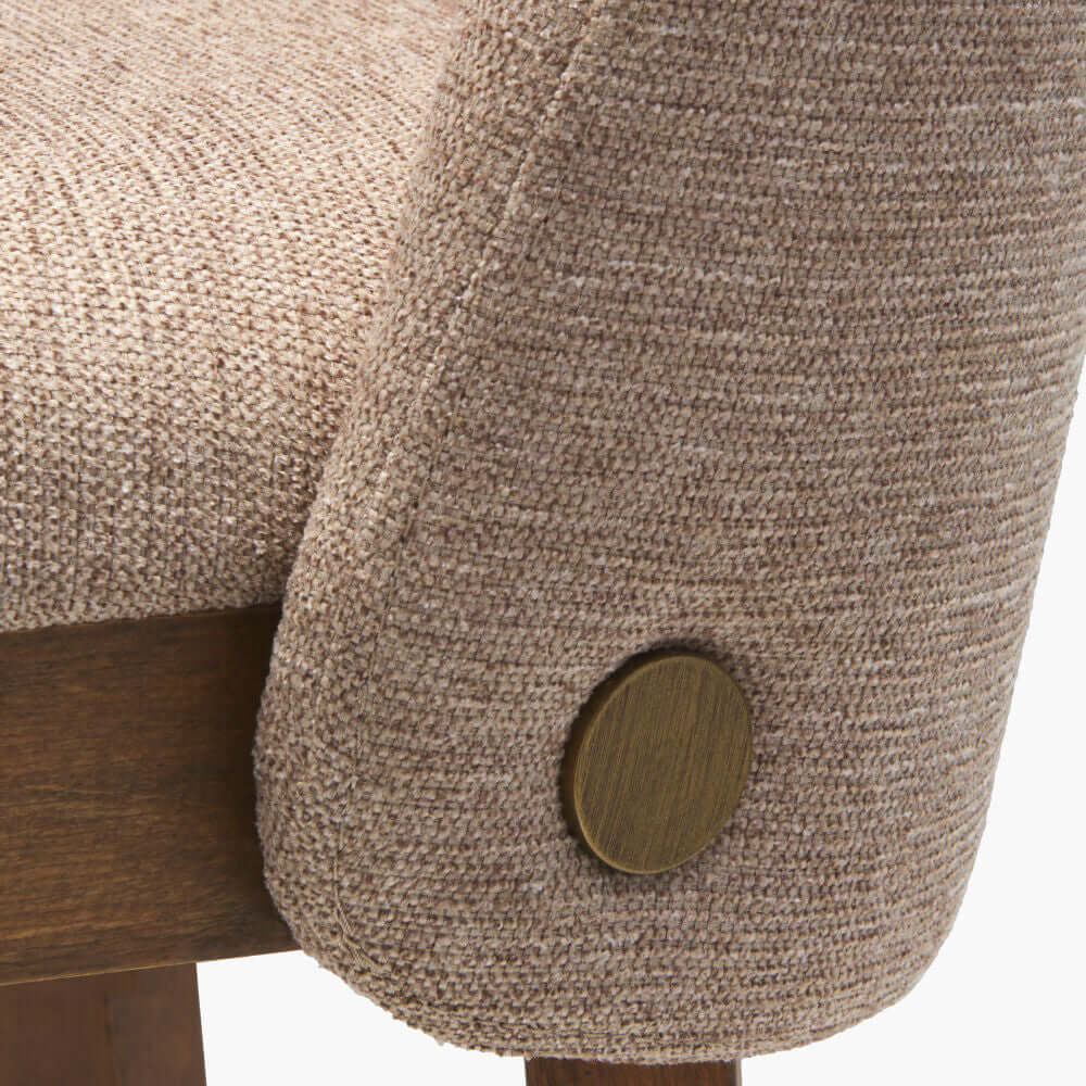 Close-up of Surya Brooke Dining Chair upholstery fabric texture and brass accent on the side.