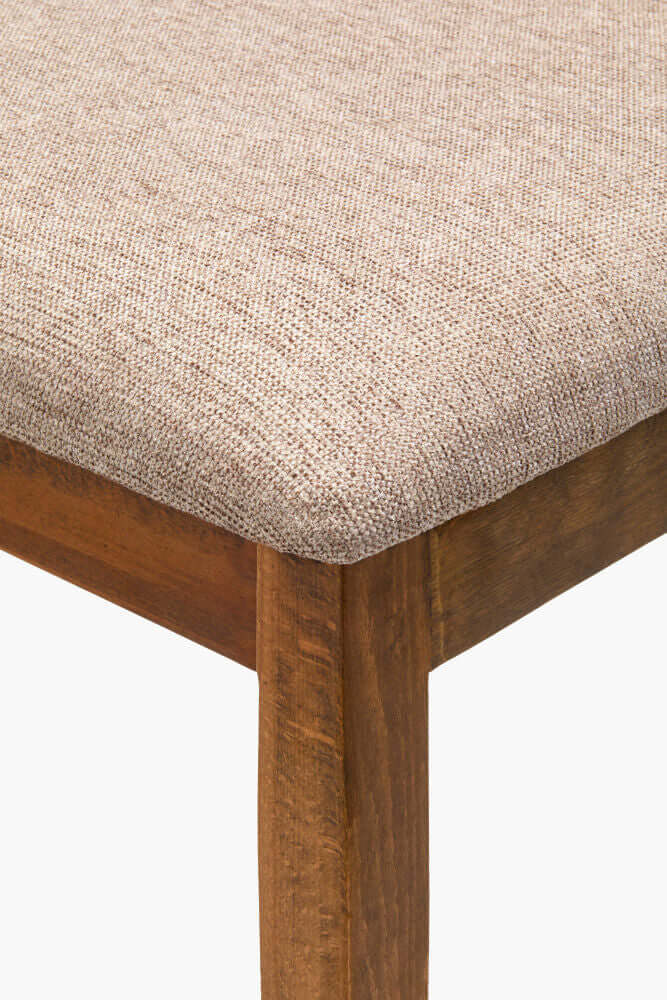 Detailed view of the Surya Brooke Dining Chair's beechwood leg finish and brown upholstered seat.