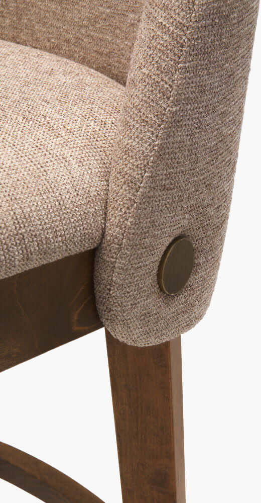 Detailed view of Surya Brooke Counter Stool backrest and bronze button accent.