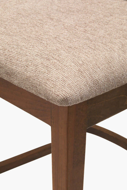 Detailed view of Surya Brooke Counter Stool showing the soft polyester seat and wooden frame.