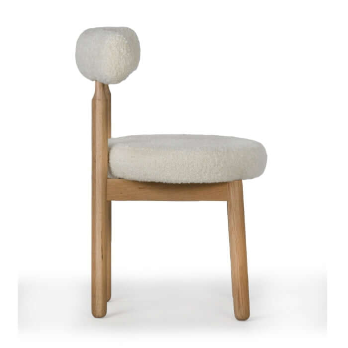 Side view of the Centro Dining Chair Natural by Union Home, highlighting the turned oak legs and curved backrest.