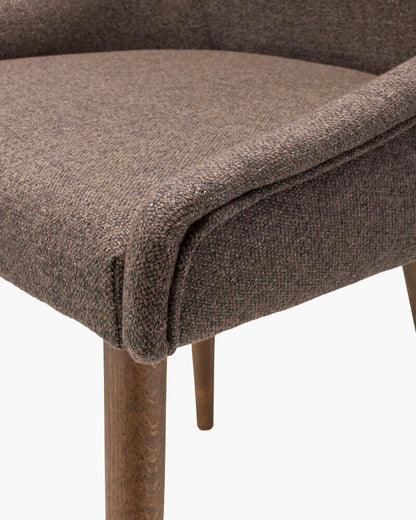 Close-up of the Halie Dining Chair seat showing the textured brown fabric and craftsmanship.