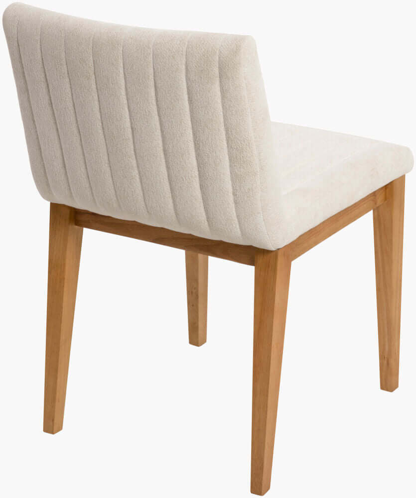 Angled rear view of the Surya Joanne Dining Chair, focusing on the sturdy wooden legs and cushioned backrest.