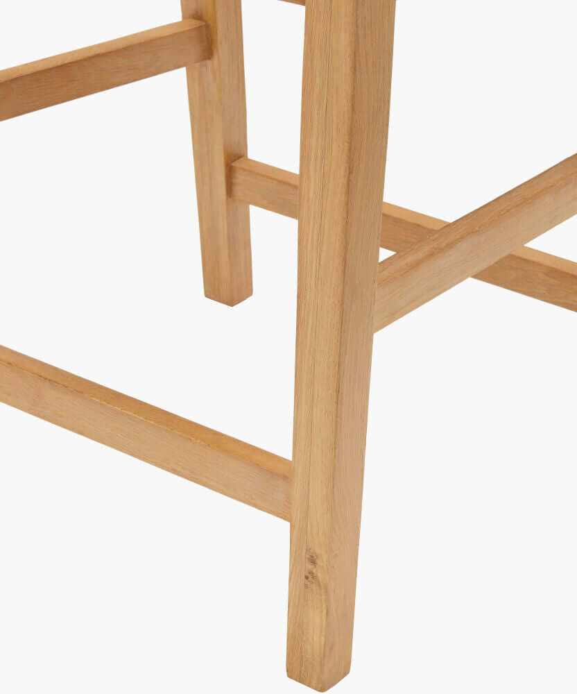 Close-up of the Surya Uintah Counter Stool's sturdy oak wood legs, highlighting the minimalist yet robust construction.