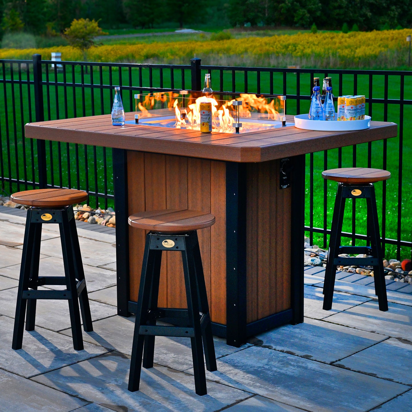 Lumin 62" Rectangular Counter Fire Table set in a serene outdoor setting during the evening.