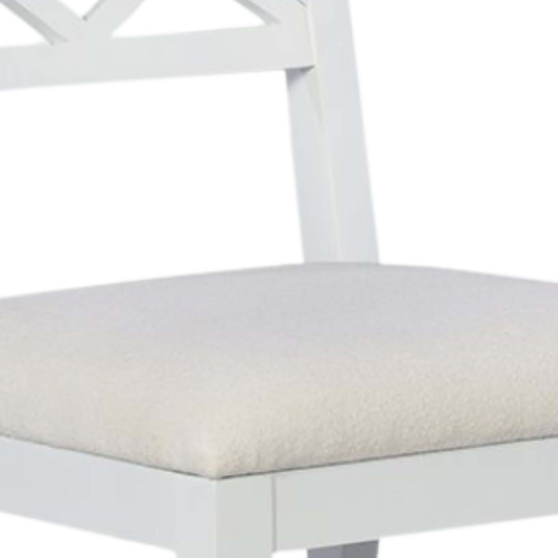 Detailed view of the drop-on upholstered seat of a white wood dining chair, showcasing its plush fabric and sturdy construction.