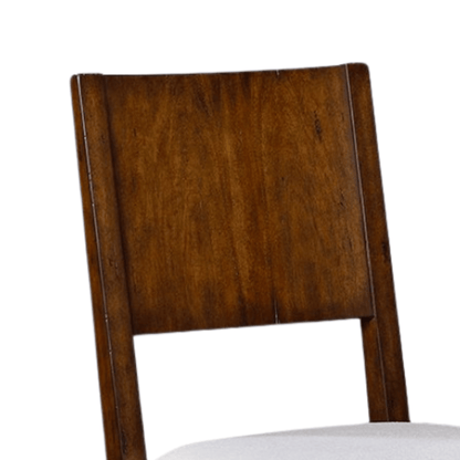 1: "Close-up of a white wood dining chair's backrest with a diamond-patterned design and a sleek ghost finish.