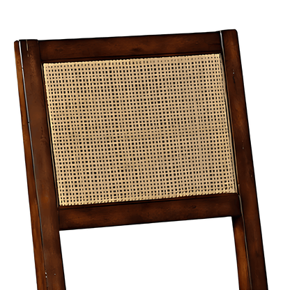 Close-up of the cane-insert backrest on a brown wooden dining chair, highlighting the classic design and syrup finish.