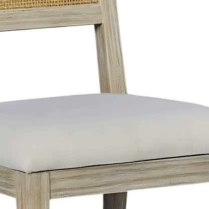 Detailed view of the upholstered seat and sturdy construction of a weathered wood dining chair with a rustic finish.