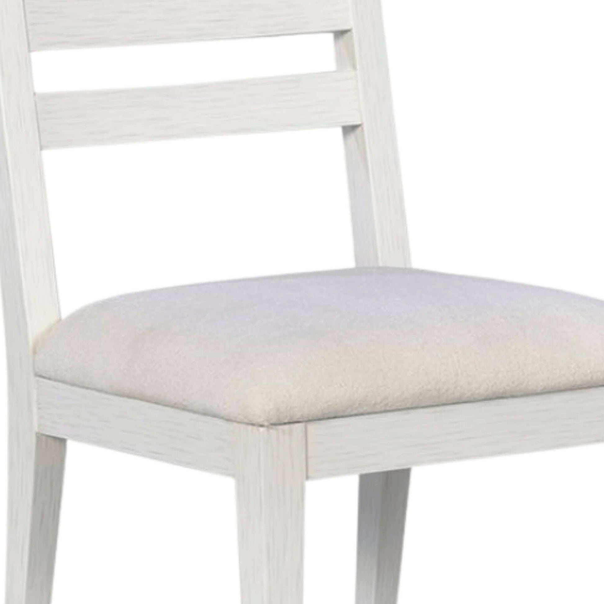 Detailed view of the upholstered seat and sturdy construction of a grey wooden dining chair with a serene ghost finish.