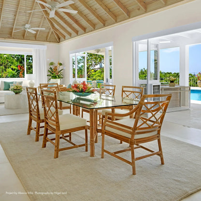 Dining room with DAVID FRANCIS Medium Rectangular Table Base and chairs in a tropical setting.