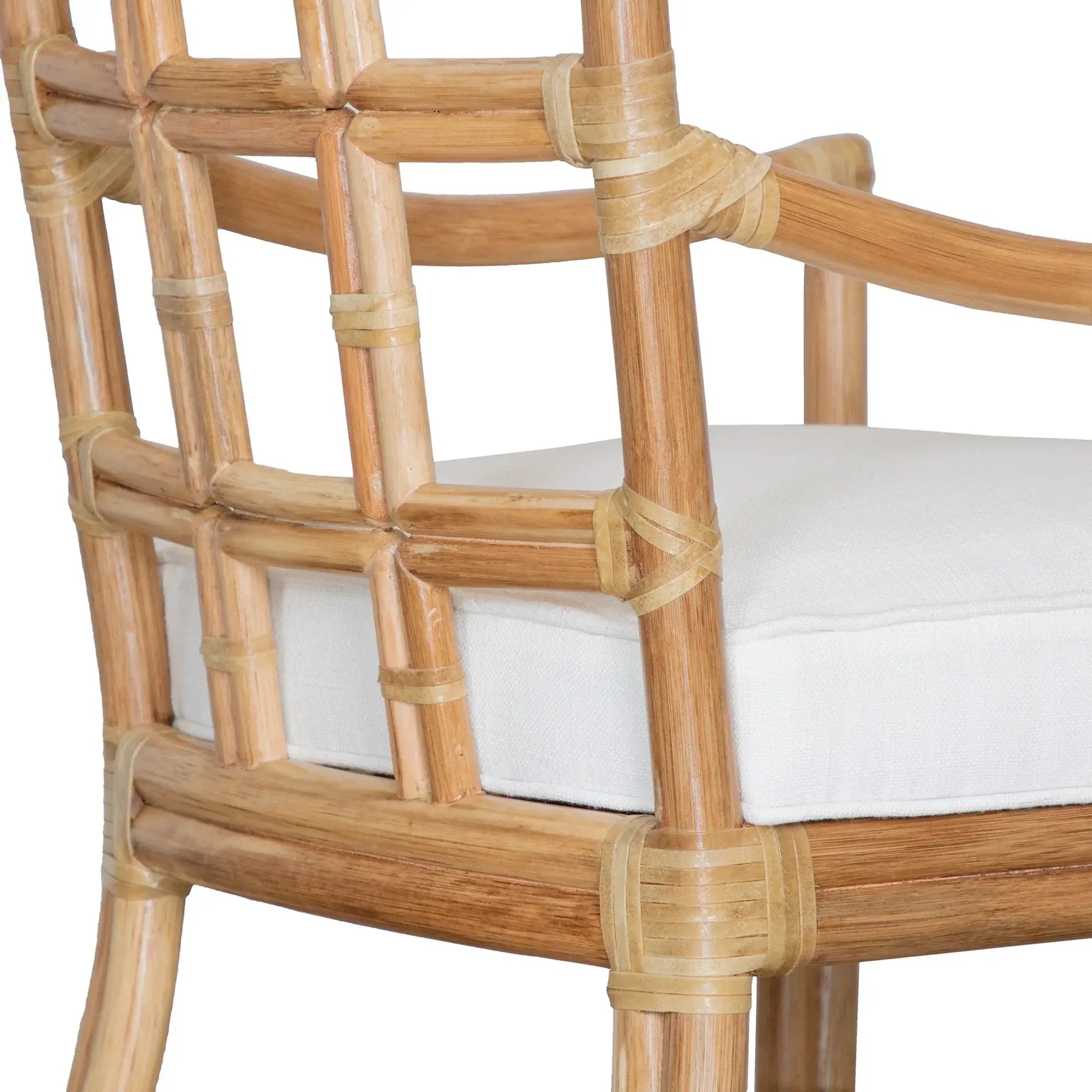 Angled back view of the Seville Armchair in natural rattan, highlighting the detailed rawhide wrapping and open pattern design.