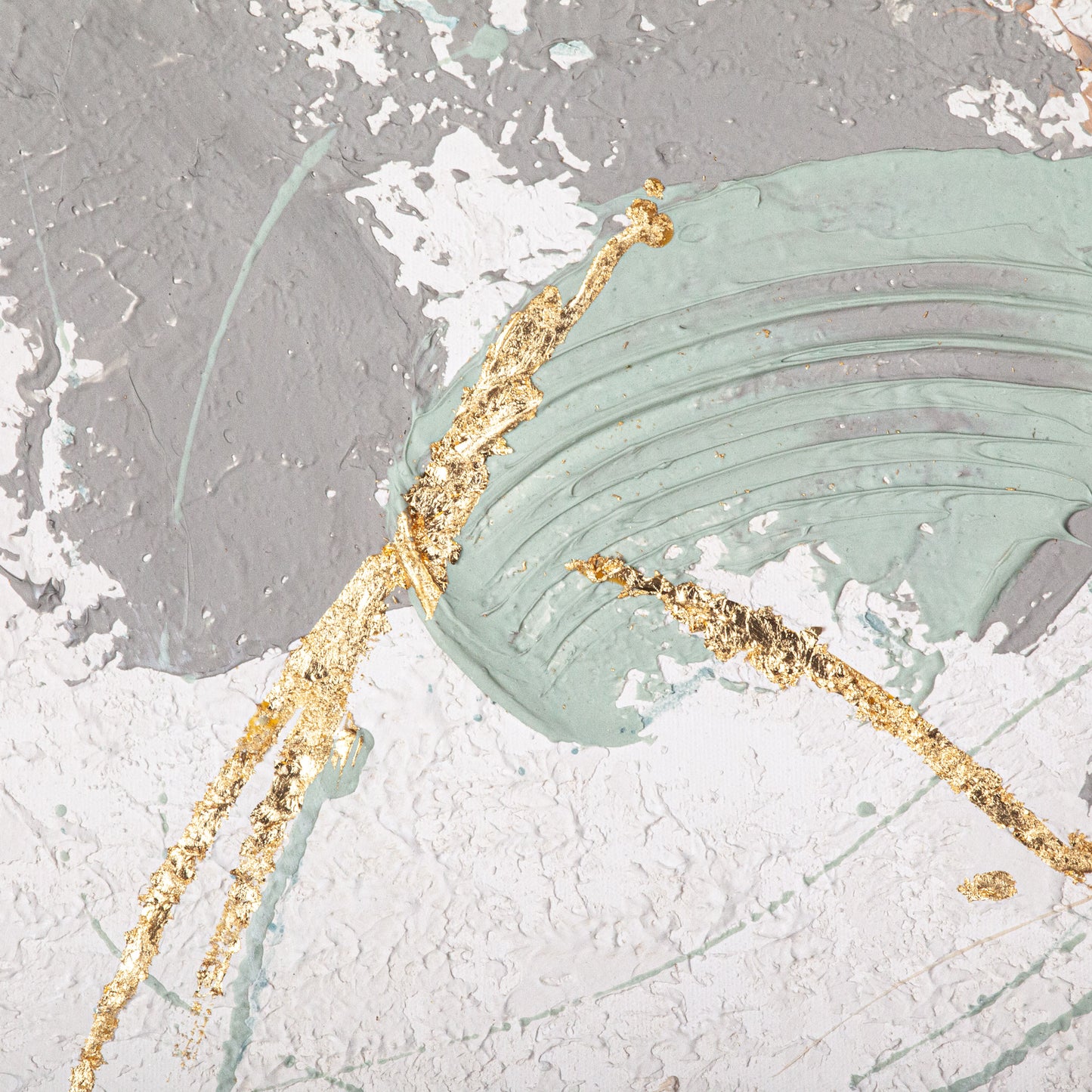 Close-up of textured hand-painted canvas featuring swirls of green, grey, and gold foil accents.