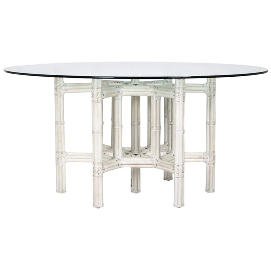 White rattan dining table base with a glass top, combining style and functionality for contemporary living spaces.