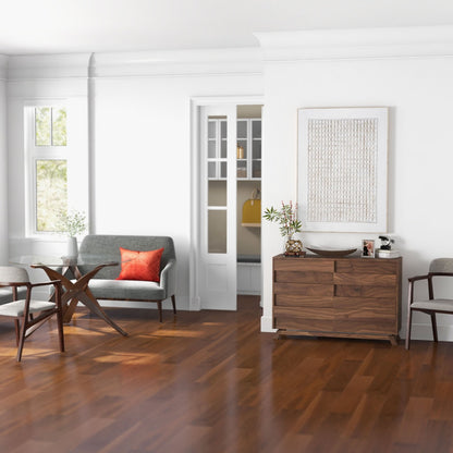 Dining room featuring Agrestal canvas above a wooden sideboard, enhancing the room's warmth.