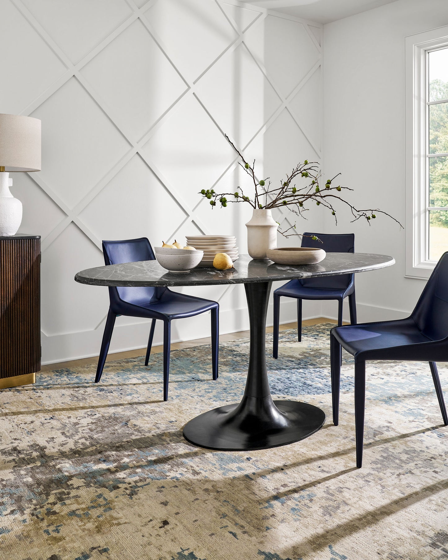 Dining room with Anatalia black marble table and stylish accessories.