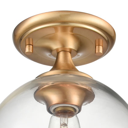 Close-up of brass base with handblown clear globe glass on semi flush mount ceiling fixture.