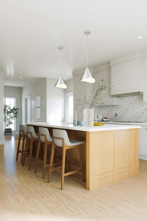 Brushed nickel conical pendant lights above wood island.