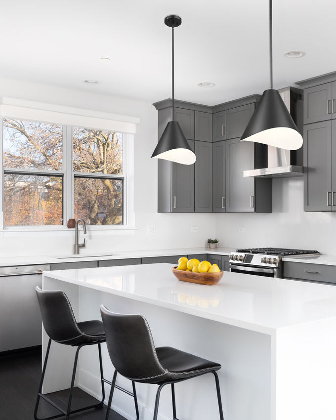 Matte black pendant lights over modern white kitchen island.