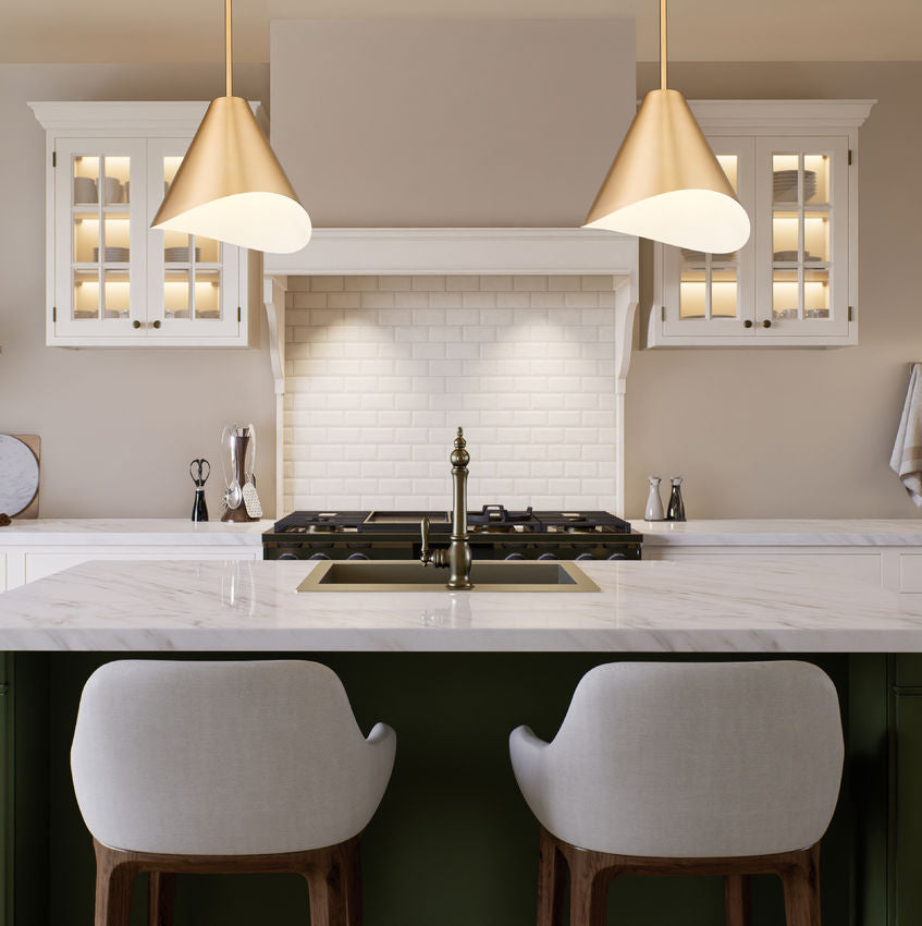 Modern gold conical pendant lights over marble kitchen island.