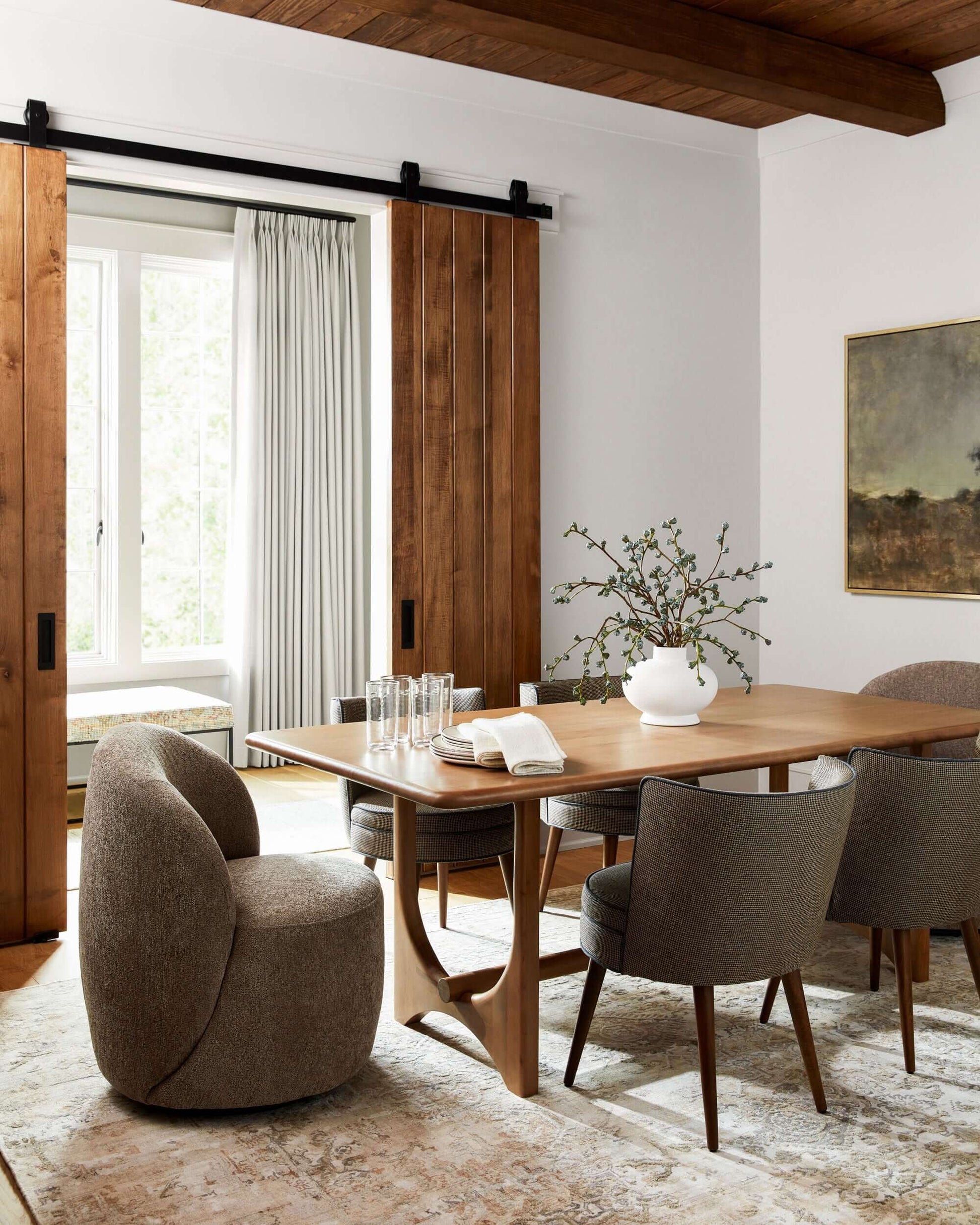 Arland Brown Scandinavian Dining Table styled in a modern dining room setting.