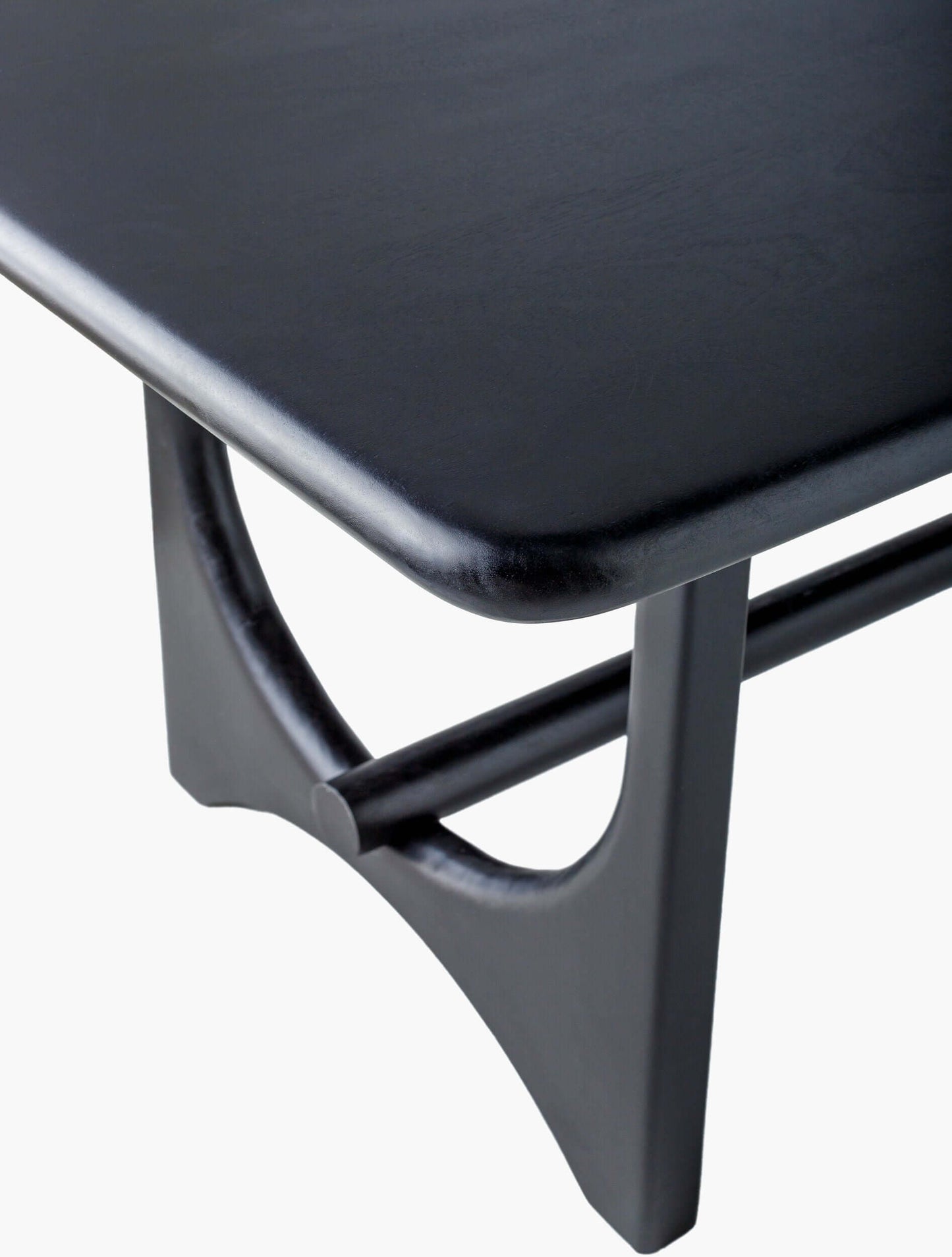 Close-up of the corner of the Surya Arland Black Dining Table showing the fine craftsmanship and smooth edges.