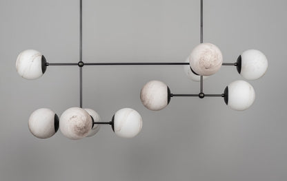 Armstrong Linear Chandelier with marble matte globes in a black gunmetal finish, unlit.