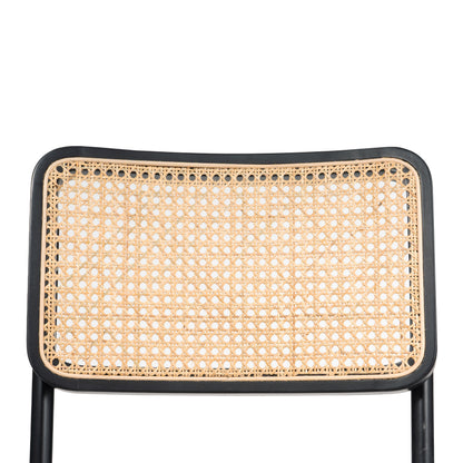 Close-up of cane weave backrest on a modern dining chair, showcasing intricate detailing and natural texture.