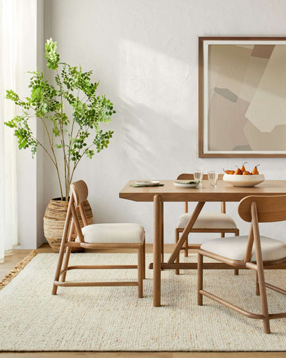 Room scene featuring the Keating Dining Table by Surya set in a modern dining room, emphasizing its elegant design and warm oak finish.