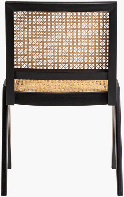 Back view of a black-frame rattan dining chair, showcasing the intricate woven design of the backrest.