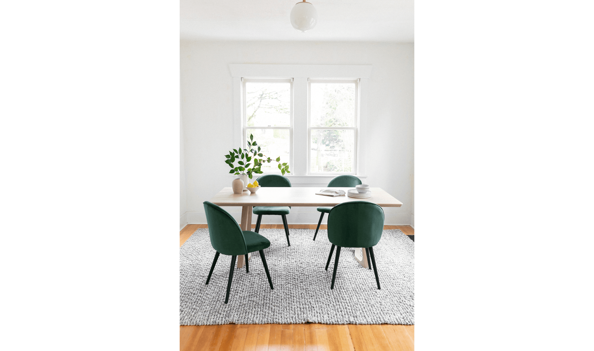 Silas White Oak Dining Table in a stylish dining room setup with green chairs.